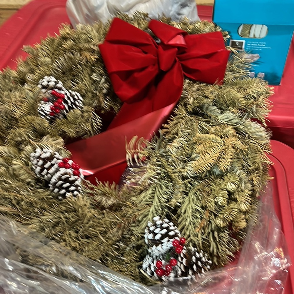 Xmas wreath red bow and colored pine cones and berries